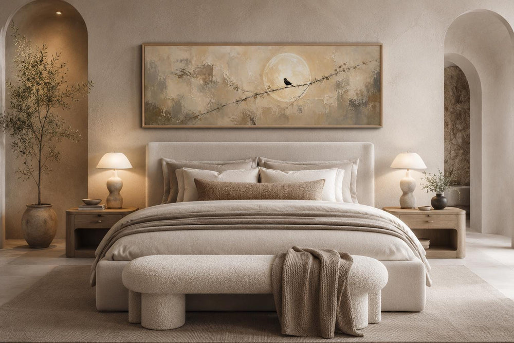 Bird on branch silhouette with moon neutral beige abstract canvas print above a bed.