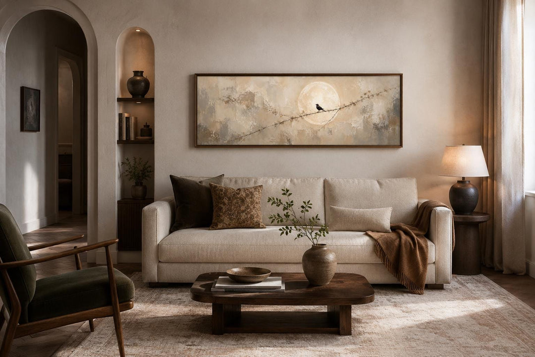 Bird on branch silhouette with moon neutral beige abstract canvas print above a sofa.