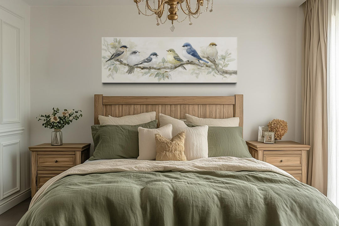 Panoramic canvas print of birds on a branch in neutral tones hanging above a wooden bed.