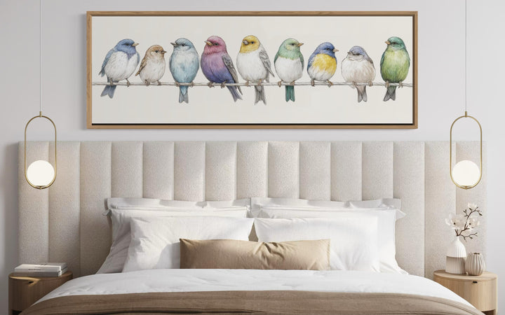 Colorful songbirds on a wire framed canvas art hanging above a modern farmhouse style bed.