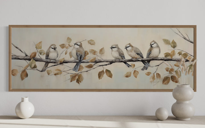 Panoramic painting of five birds on a branch with autumn leaves in a distressed wood frame.