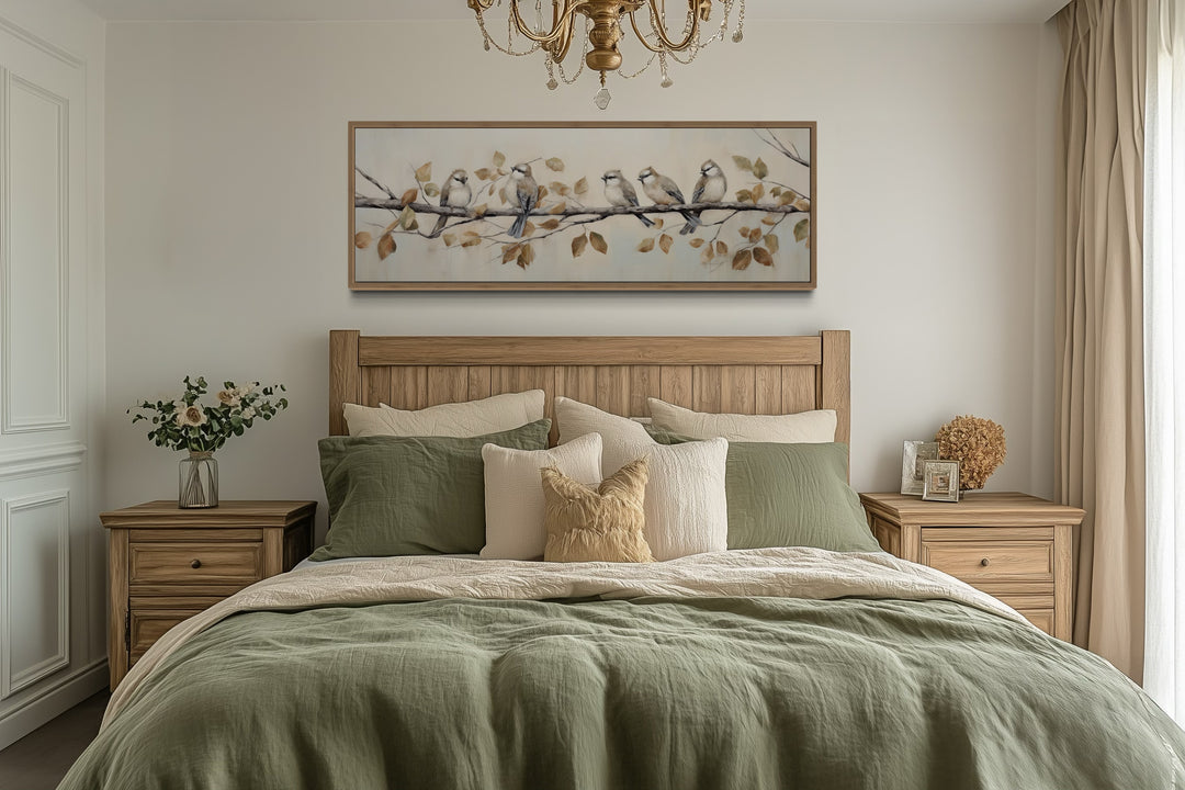 Panoramic framed canvas wall art of birds on a branch above a bed in a rustic farmhouse bedroom.