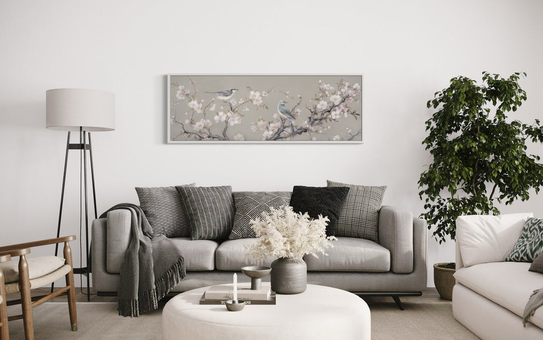 Horizontal framed canvas art of birds on a blossoming branch.