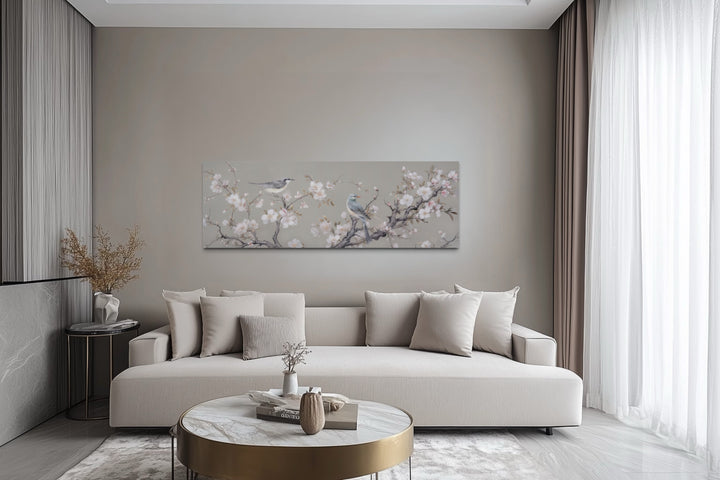Horizontal framed canvas art of birds on a blossoming branch.