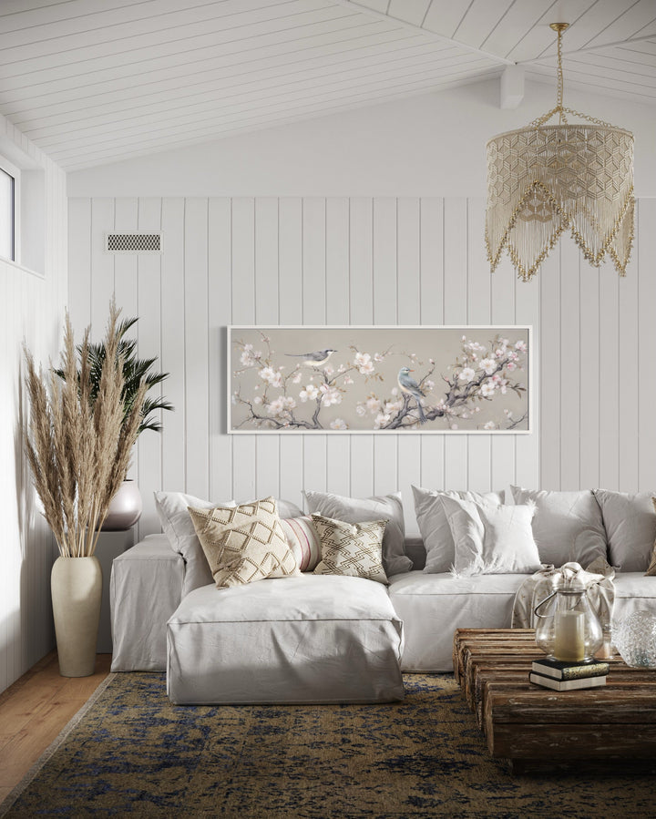 Horizontal framed canvas art of birds on a blossoming branch.