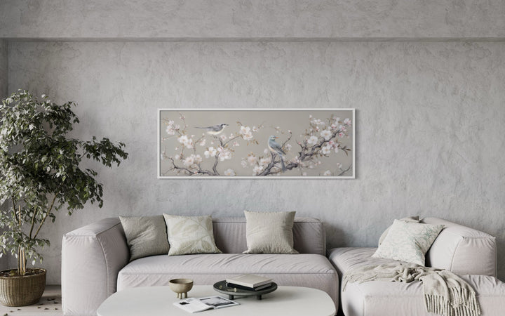 Horizontal framed canvas art of birds on a blossoming branch.