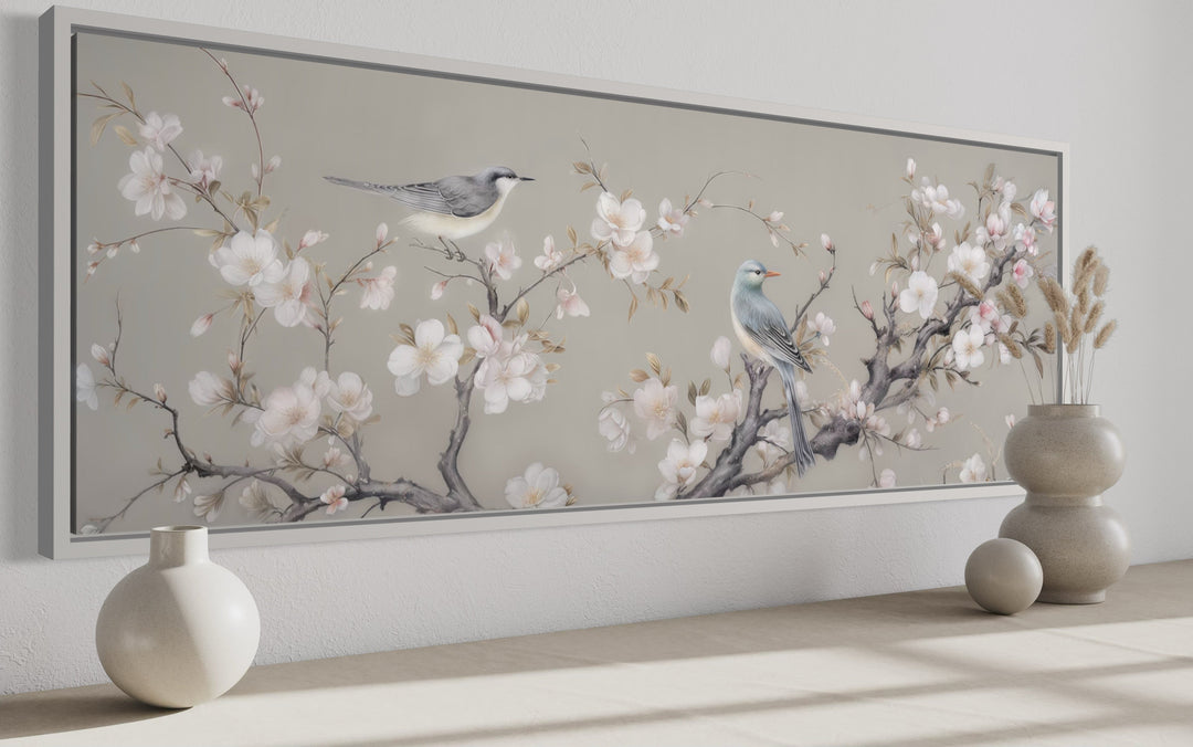 Horizontal framed canvas art of two birds on a blossoming branch.