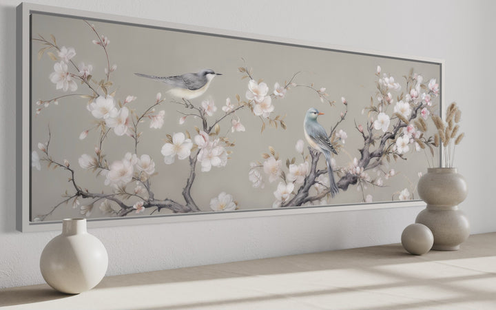 Horizontal framed canvas art of two birds on a blossoming branch.