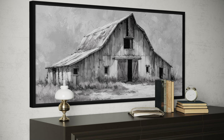 Black and white rustic farmhouse canvas print of a weathered barn on a dark wood dresser.