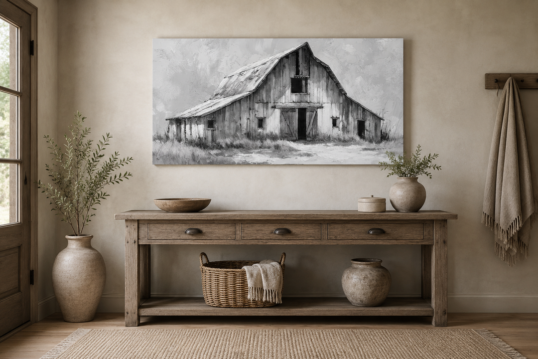 Black and white barn canvas print above a rustic wooden console table in a farmhouse interior.