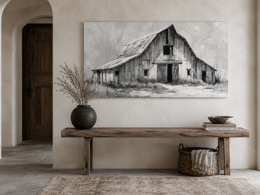 Black and white barn canvas wall art above a rustic wooden bench in a farmhouse entryway.