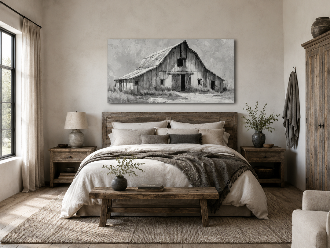 Black and white barn canvas print above a rustic wooden bed in a farmhouse style bedroom.