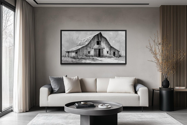 Black and white rustic barn canvas print displayed in a modern minimalist living room.
