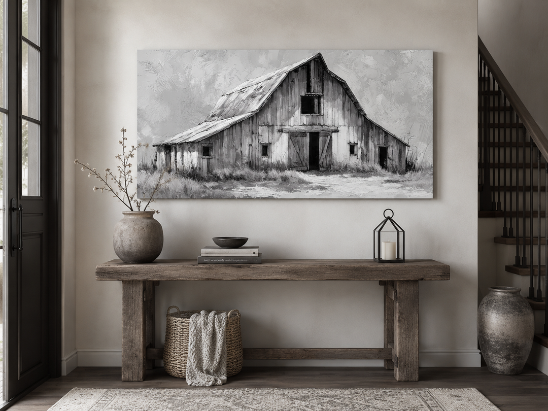 Black and white barn canvas print on a wall above a rustic wooden console table in a farmhouse room.