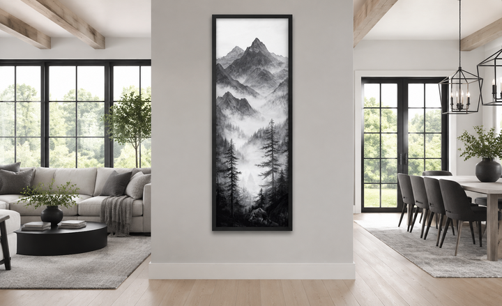 Black and white long vertical canvas art of foggy mountains and pine trees in a modern living room.