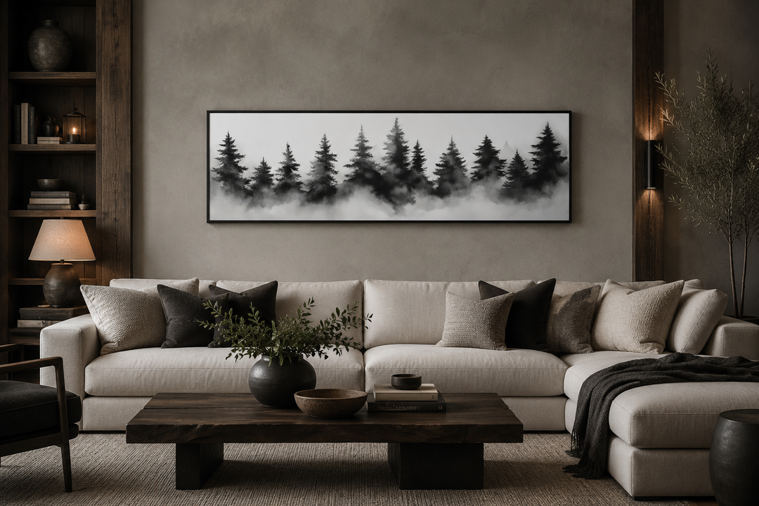 Black and white watercolor foggy pine tree forest horizontal canvas wall art above a sofa.
