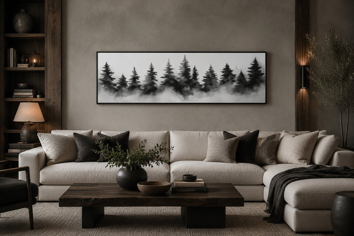Black and white watercolor foggy pine tree forest horizontal canvas wall art above a sofa.