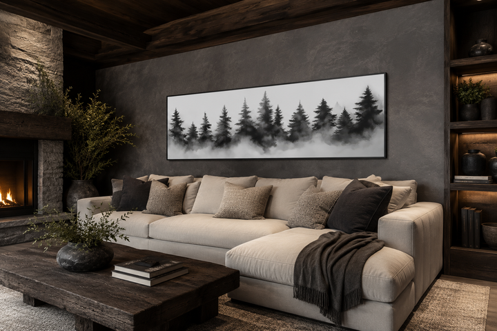 Black and white watercolor foggy pine tree forest horizontal canvas wall art above a beige sofa.