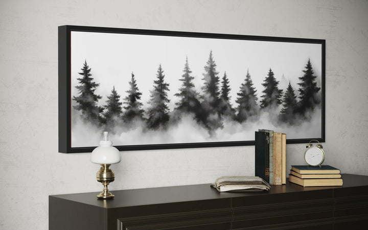 Horizontal black and white watercolor canvas art of a foggy pine tree forest in a black frame.