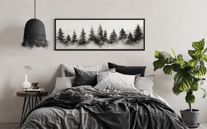 Black and white watercolor foggy pine tree forest horizontal canvas wall art above a bed.