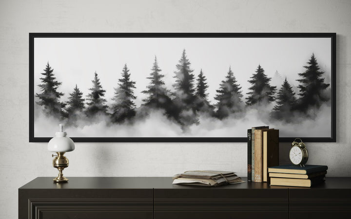 Black and white watercolor foggy pine tree forest horizontal canvas wall art above a dark console.