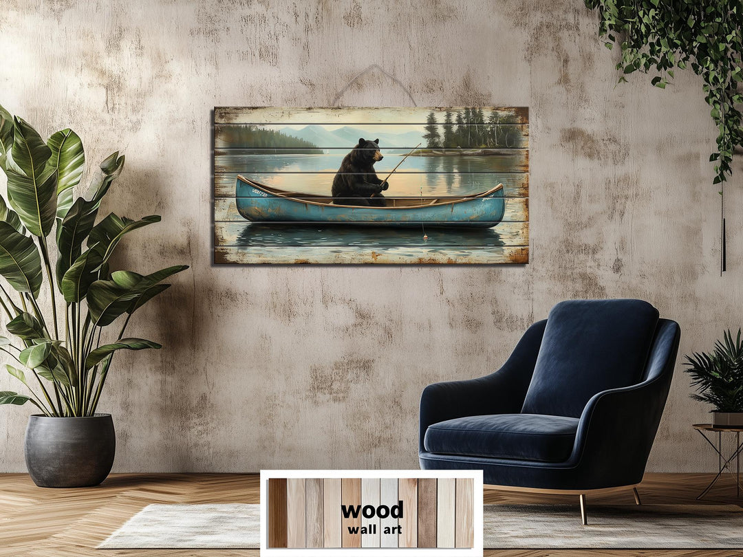 Rustic wood wall art featuring a black bear fishing in a blue canoe on a calm lake.