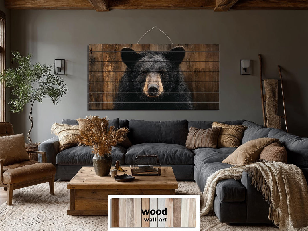 Large horizontal wood wall art featuring a realistic black bear portrait in a rustic living room.