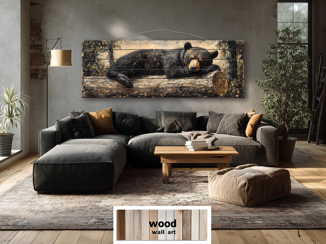 Horizontal wood wall art featuring a black bear sleeping on a log in a rustic living room.