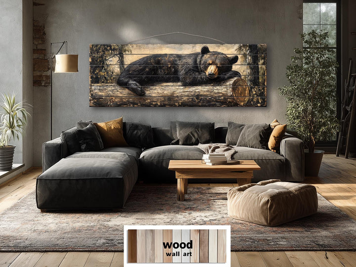 Horizontal wood wall art featuring a black bear sleeping on a log in a rustic living room.
