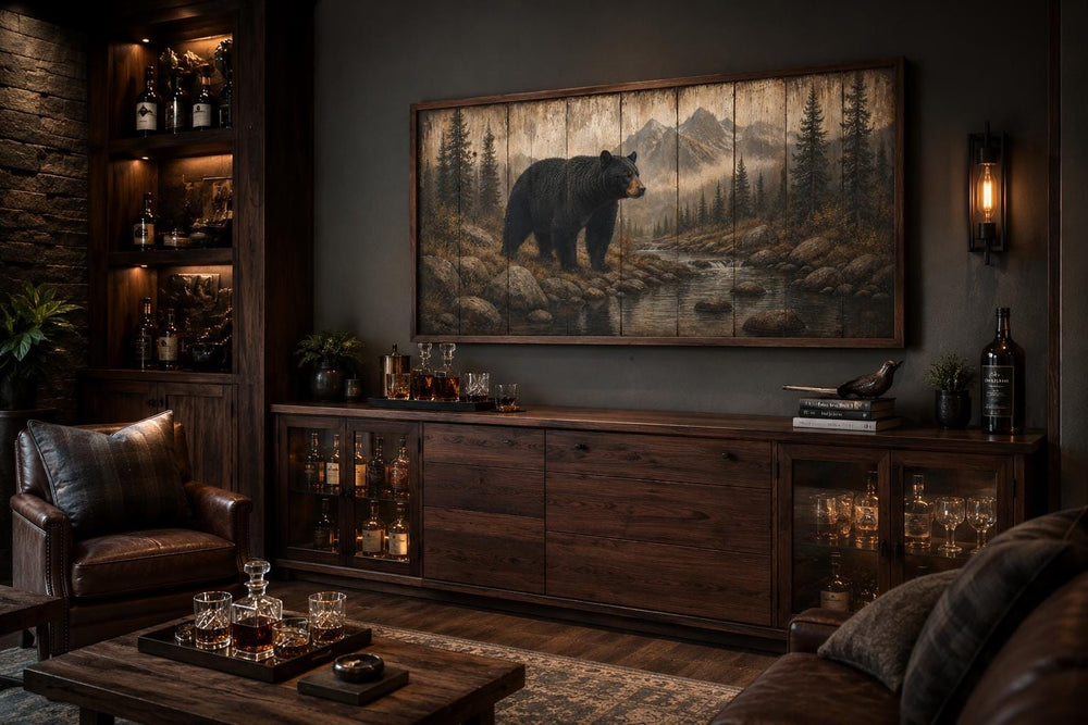 Rustic black bear canvas print wall art in a mountain forest scene above a dark wood sideboard.