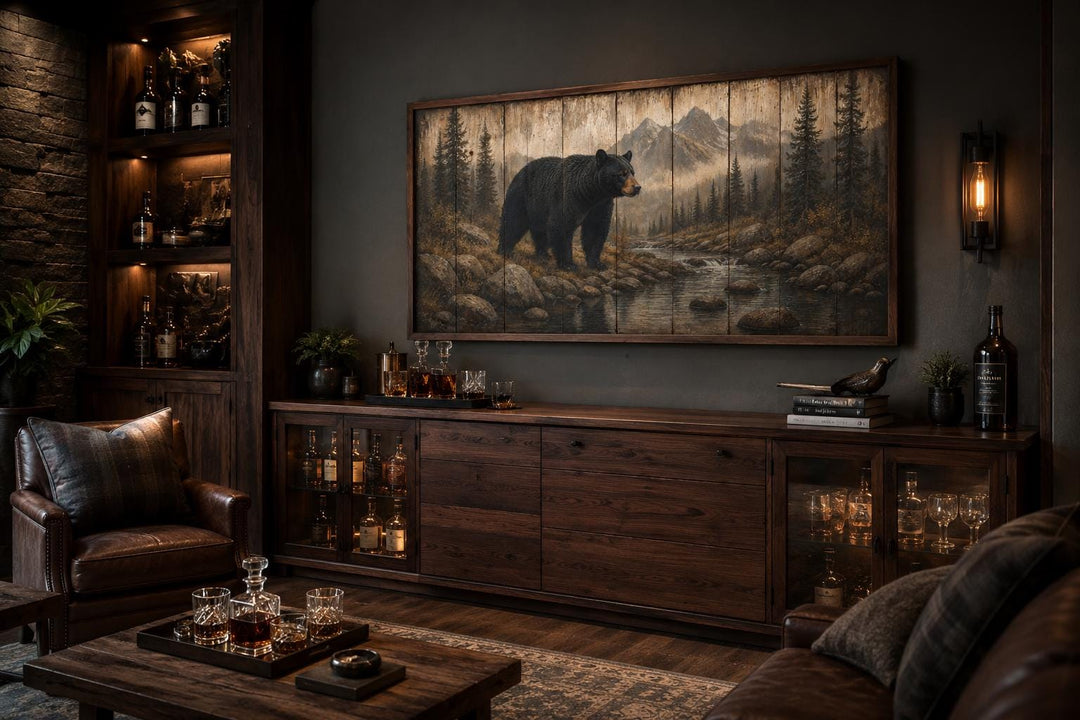 Rustic black bear canvas print wall art in a mountain forest scene above a dark wood sideboard.