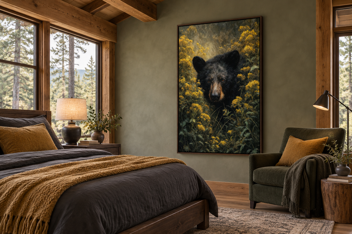 Black bear in yellow wildflowers framed canvas wall art in a rustic cabin bedroom.