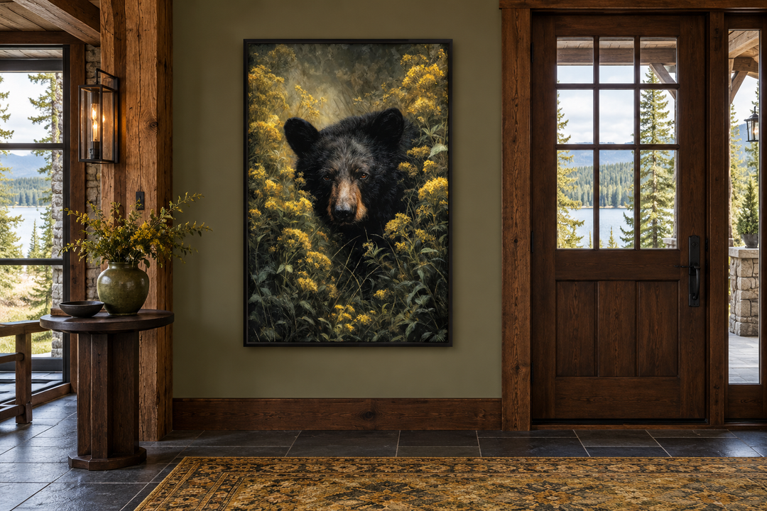 Black Bear in Yellow Wildflowers framed canvas wall art in a rustic cabin entryway.