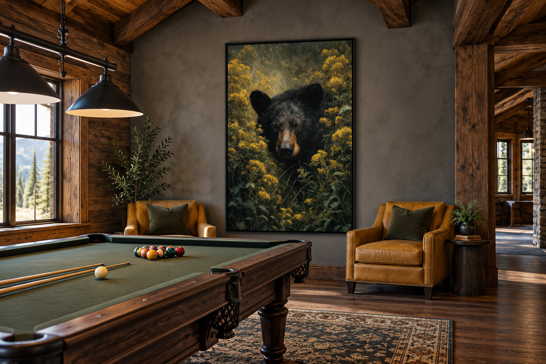 Black bear in yellow wildflowers framed canvas wall art in a rustic cabin game room.