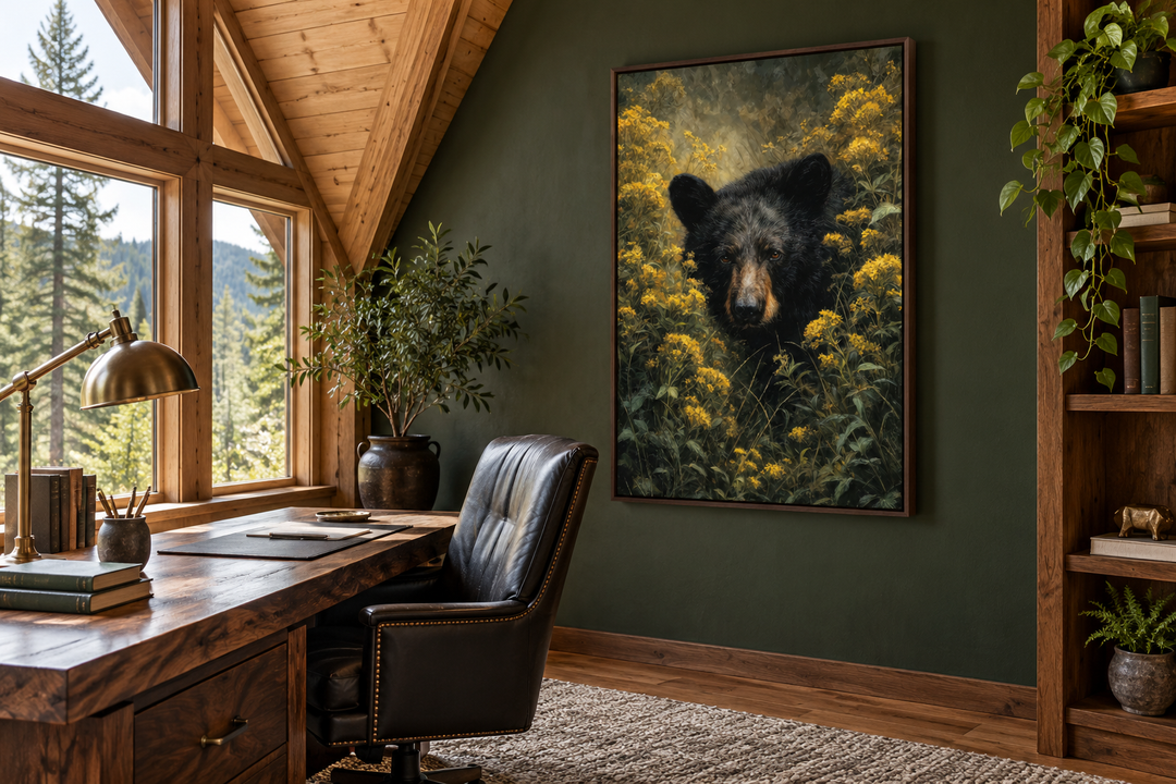 Black bear in yellow wildflowers framed canvas wall art in a rustic home office with green walls.