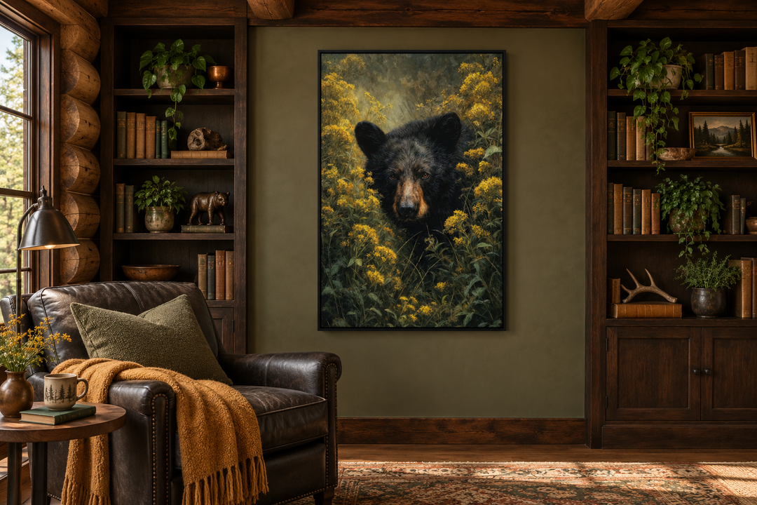 Black bear in yellow wildflowers framed canvas wall art in a rustic cabin library setting.