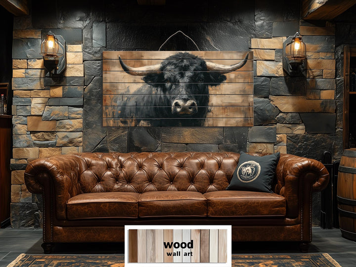 Large horizontal wood wall art featuring a black bull portrait on rustic planks above a leather sofa.