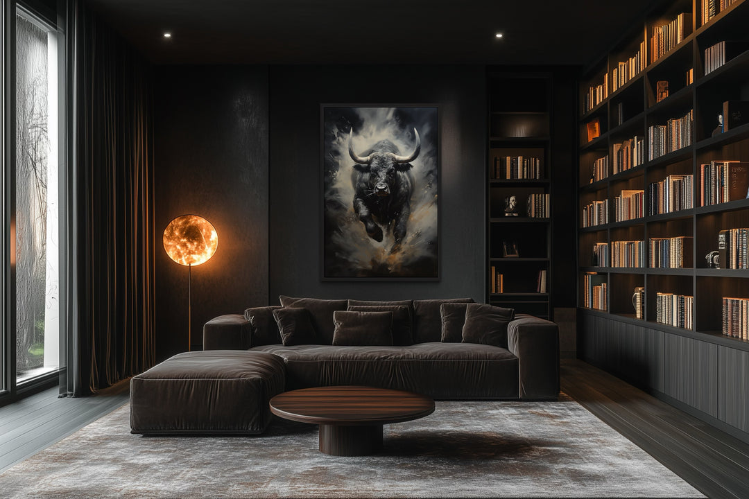Framed abstract canvas of a charging black bull on a dark wall in a modern office or living room.