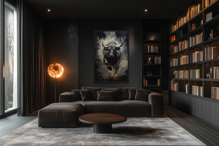 Framed abstract canvas of a charging black bull on a dark wall in a modern office or living room.