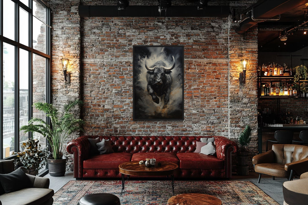 Black charging bull abstract framed canvas wall art hanging on a brick wall in a modern office.