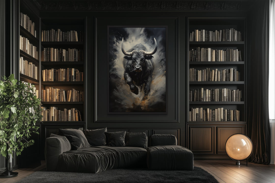 Framed canvas wall art of a charging black bull in a dark, modern office with built-in bookshelves.