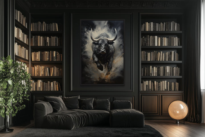 Framed canvas wall art of a charging black bull in a dark, modern office with built-in bookshelves.