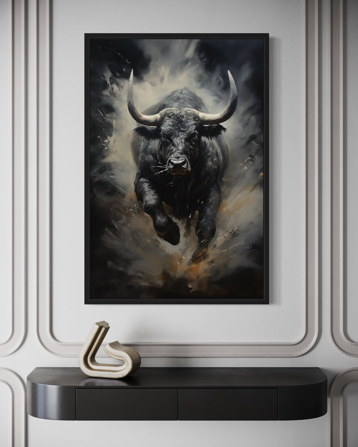 Black charging bull abstract framed canvas wall art hanging above a black console table.