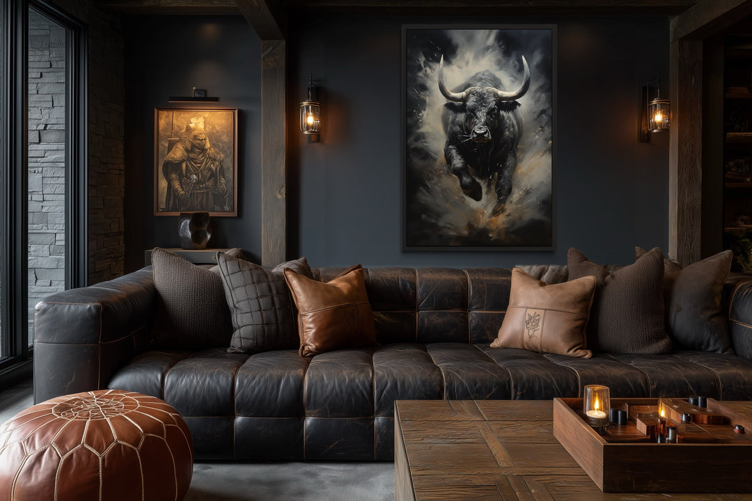 Framed canvas wall art of a charging black bull in a dark, masculine office with a leather sofa.