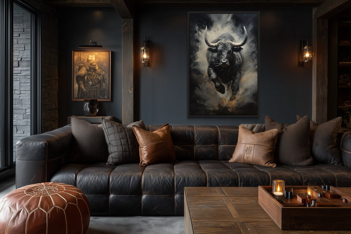 Framed canvas wall art of a charging black bull in a dark, masculine office with a leather sofa.