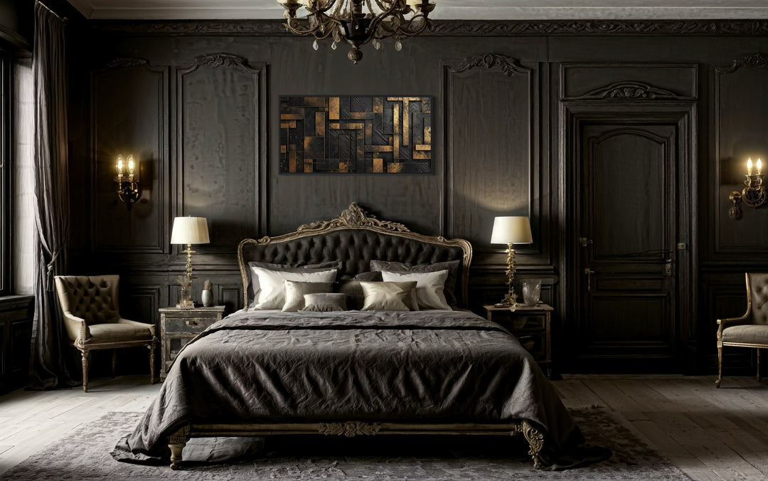 Black and gold abstract geometric framed canvas wall art hanging above a bed in a dark bedroom.