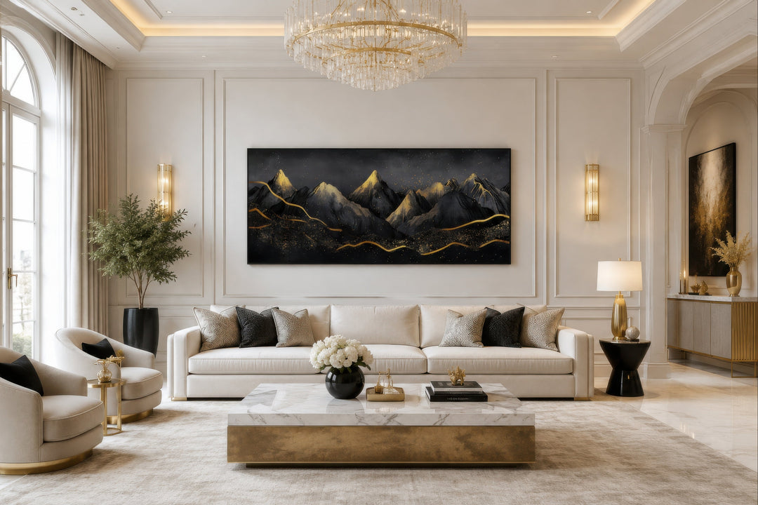Black gold abstract mountain framed canvas wall art hanging above a white sofa in a living room.