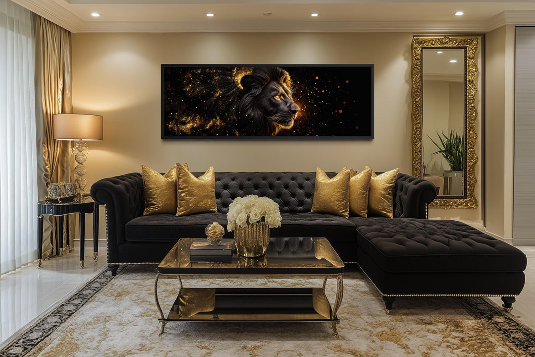 A long horizontal framed canvas of a black and gold lion hangs above a luxury black velvet sofa.