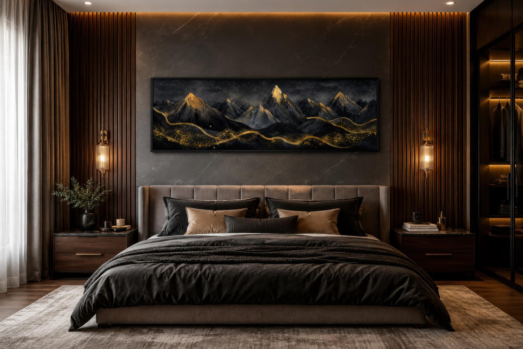 Long narrow canvas wall art featuring black and gold abstract mountains above a modern bed.