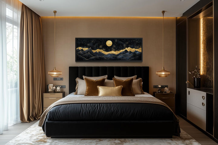A panoramic canvas print of a black and gold mountain landscape hangs above a modern bed.